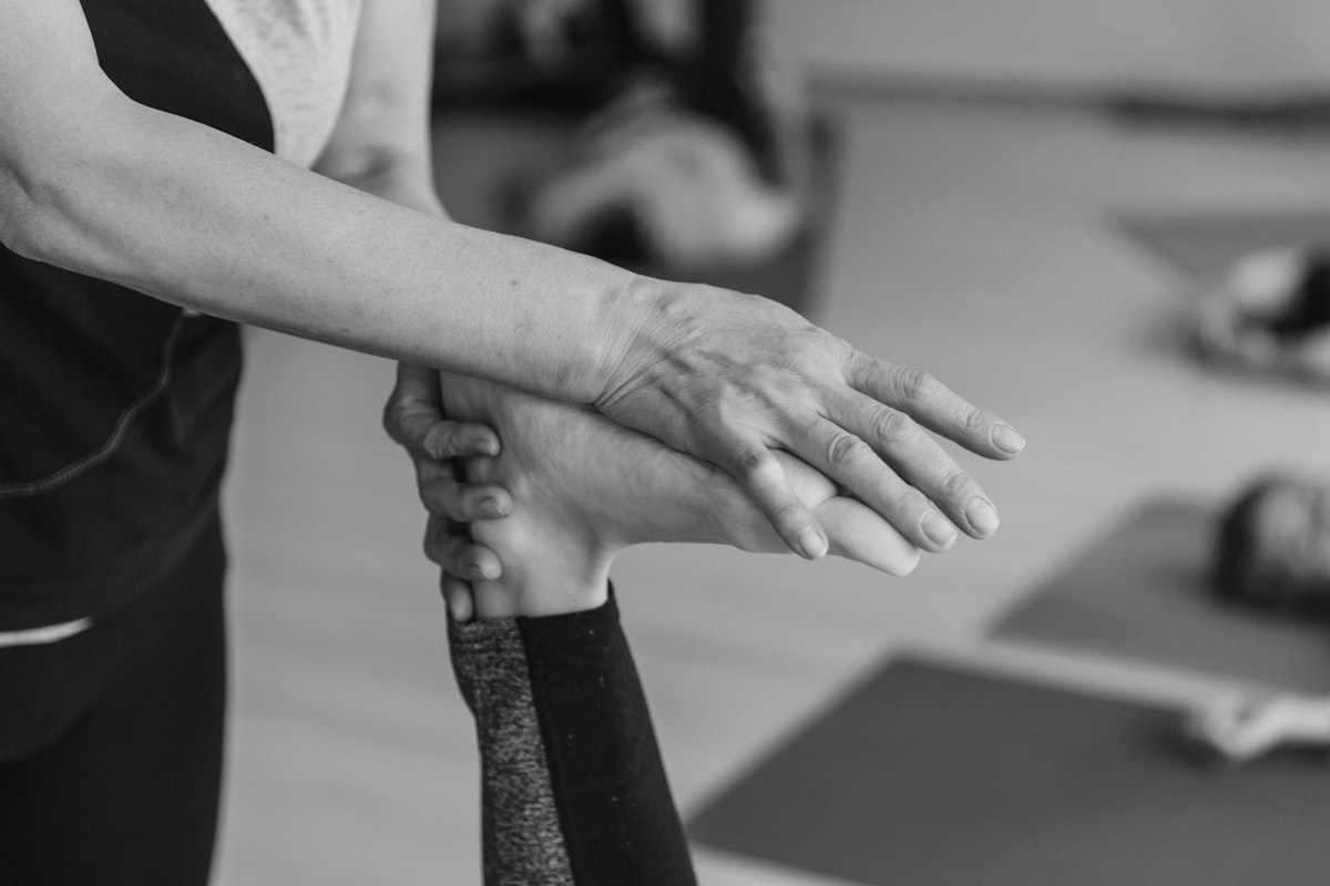 Professional kinesiotherapy instructor demonstrating correct movement technique